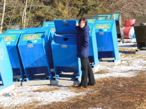 Edson and District Recycling Society community program coordinator Diana Comiak stands beside the new beverage recycling bins.